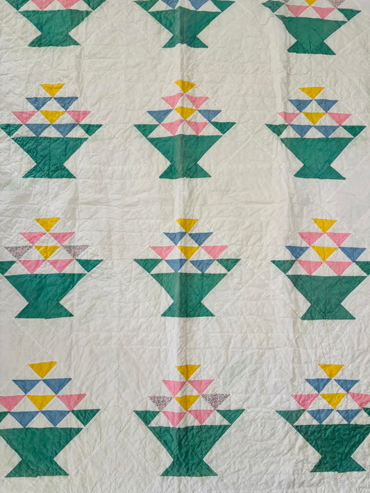 Vintage and hand sewn basket quilt in green, blue, yellow and pink
